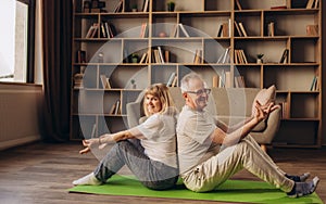 Senior couple is doing fitness training at home. Doing yoga together. Healthy lifestyle concept