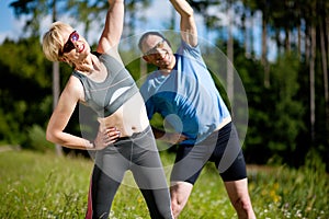 Senior couple doing sport exercising outdoors