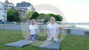 Senior couple doing yoga outdoors. Healthy lifestyle concept