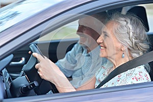 Senior couple driving car