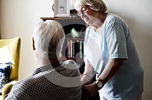 Senior couple, elderly woman taking care of an elderly man