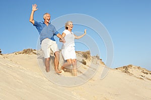 Senior Couple Enjoying Beach Holiday Running