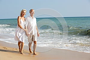 Senior Couple Enjoying Beach Holiday In The Sun