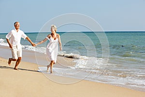 Senior Couple Enjoying Beach Holiday In The Sun