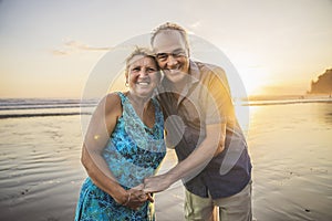 Senior Couple Enjoying Beautiful Sunset on the Beach