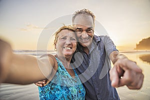 Senior Couple Enjoying Beautiful Sunset on the Beach