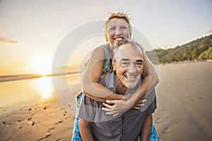 Senior Couple Enjoying Beautiful Sunset on the Beach