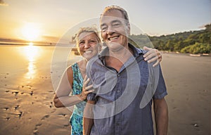 Senior Couple Enjoying Beautiful Sunset on the Beach