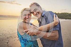 Senior Couple Enjoying Beautiful Sunset on the Beach