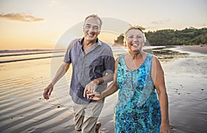 Senior Couple Enjoying Beautiful Sunset on the Beach