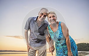 Senior Couple Enjoying Beautiful Sunset on the Beach