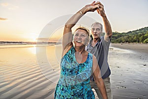 Senior Couple Enjoying Beautiful Sunset on the Beach