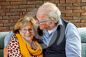 Senior Couple Enjoying Close Moment on Sofa