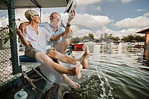 Senior couple enjoying a day in the cottage near the river