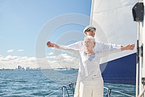 Senior couple enjoying freedom on sail boat in sea