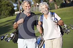 Senior Couple Enjoying Game Of Golf photo
