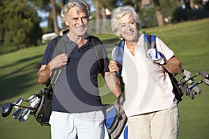 Senior Couple Enjoying Game Of Golf