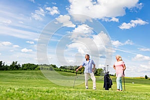 Senior couple enjoying golf game.