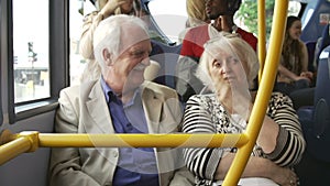 Senior Couple Enjoying Journey On Bus