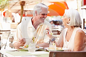 Senior Couple Enjoying Lunch In Outdoor Restaurant