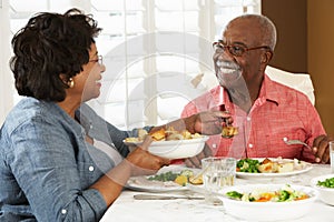 Senior Couple Enjoying Meal At Home