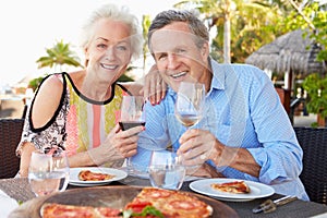 Senior Couple Enjoying Meal In Outdoor Restaurant