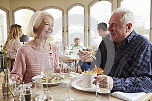 Senior Couple Enjoying Meal In Restaurant Together