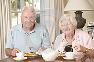 Senior Couple Enjoying Meal Together At Home