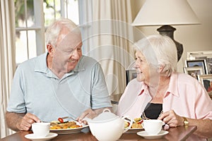 Senior Couple Enjoying Meal Together At Home