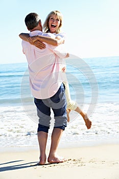 Senior Couple Enjoying Romantic Beach Holiday