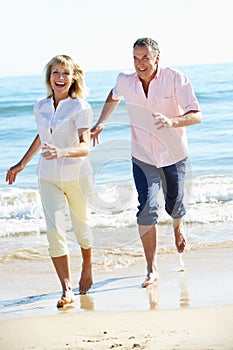 Senior Couple Enjoying Romantic Beach Holiday