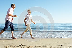 Senior Couple Enjoying Romantic Beach Holiday