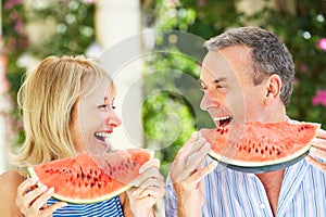 Senior Couple Enjoying Slices Of Water Melon