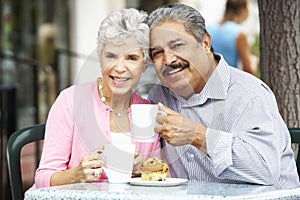 Senior Couple Enjoying Snack At Outdoor CafÃÂ½
