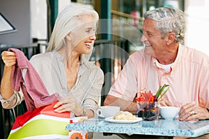 Senior Couple Enjoying Snack At Outdoor Cafe