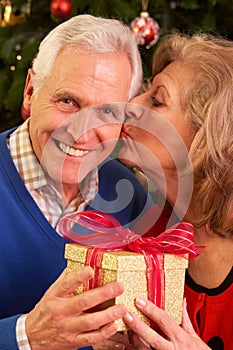 Senior Couple Exchanging Christmas Gifts photo