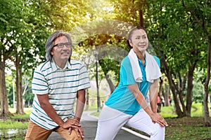 Senior couple exercise concept. man and woman stretching before exercising together in the public park