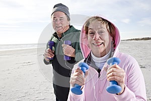 Senior couple exercising on beach