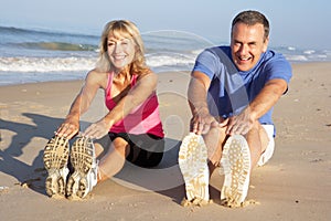 Senior Couple Exercising On Beach