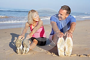 Senior Couple Exercising On Beach