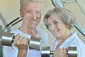 Senior couple exercising with dumbbells