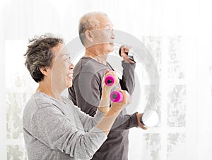 senior couple exercising with dumbbells