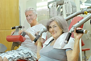 Senior Couple Exercising In gym