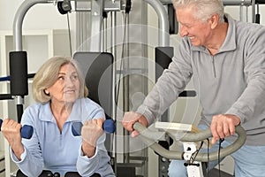 Senior couple exercising in gym