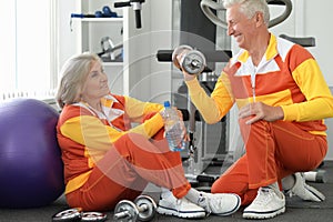 Senior couple exercising in gym