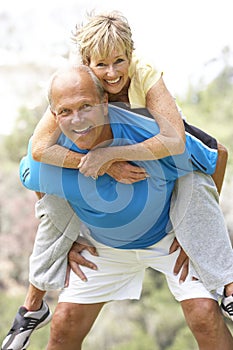 Senior Couple Exercising In Park