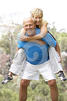 Senior Couple Exercising In Park