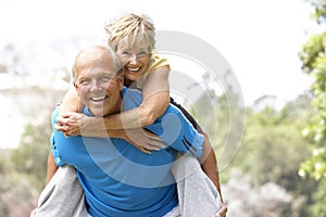 Senior Couple Exercising In Park