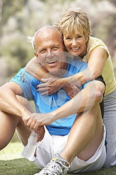 Senior Couple Exercising In Park