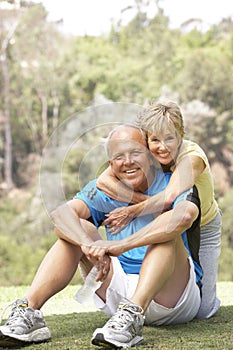 Senior Couple Exercising In Park